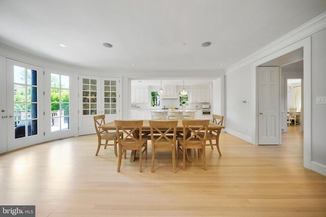 5033 Tilden St NW, Washington, DC 20016 - dining room featuring crown molding, light wood-style floors, and baseboards