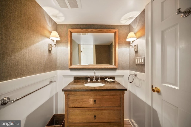 5033 Tilden St NW, Washington, DC 20016 - bathroom featuring wallpapered walls, vanity, and wainscoting