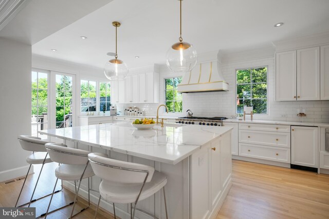 5033 Tilden St NW, Washington, DC 20016 - kitchen with custom range hood, decorative backsplash, white cabinetry, and recessed lighting