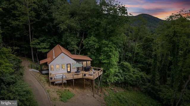 171 Honeymoon Hollow Rd, Lost City, WV 26810 - back of property featuring dirt driveway, a wooded view, and a deck with mountain view