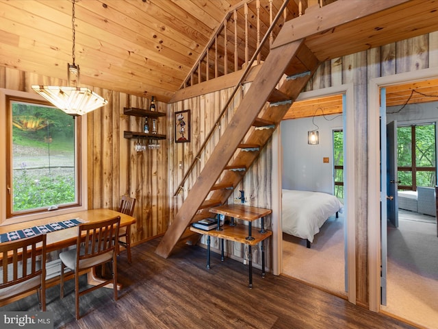 171 Honeymoon Hollow Rd, Lost City, WV 26810 - dining room with vaulted ceiling, wood finished floors, stairs, wood walls, and healthy amount of natural light