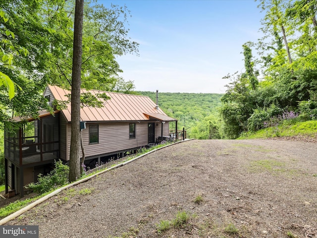 171 Honeymoon Hollow Rd, Lost City, WV 26810 - view of side of home featuring a standing seam roof, metal roof, and driveway
