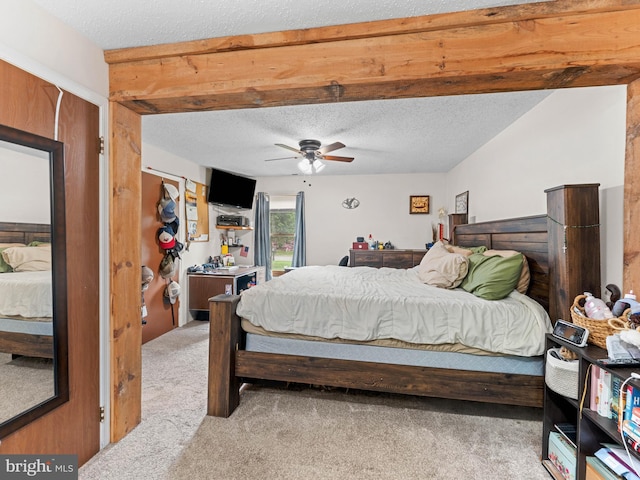 bedroom with light colored carpet, a textured ceiling, and ceiling fan