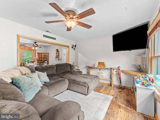 living room featuring ceiling fan and wood finished floors