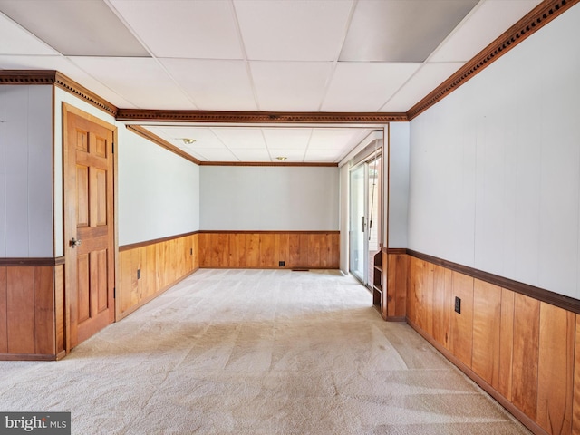 108 S 2nd St, Denton, MD 21629 - empty room featuring a drop ceiling, wood walls, light colored carpet, wainscoting, and crown molding
