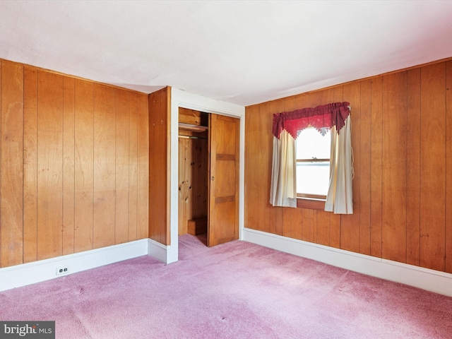 108 S 2nd St, Denton, MD 21629 - unfurnished bedroom with carpet flooring, wood walls, and a closet