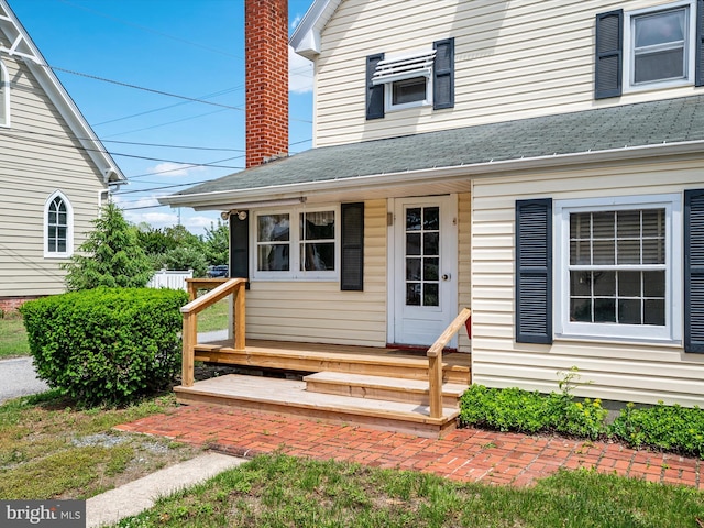 108 S 2nd St, Denton, MD 21629 - property entrance with a shingled roof