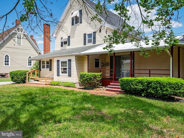 108 S 2nd St, Denton, MD 21629 - view of front of house with a front yard, a porch, and a chimney