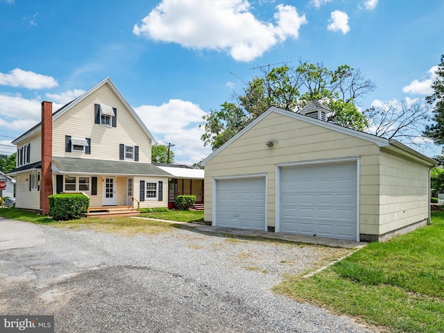 108 S 2nd St, Denton, MD 21629 - view of front of property featuring a detached garage and an outbuilding