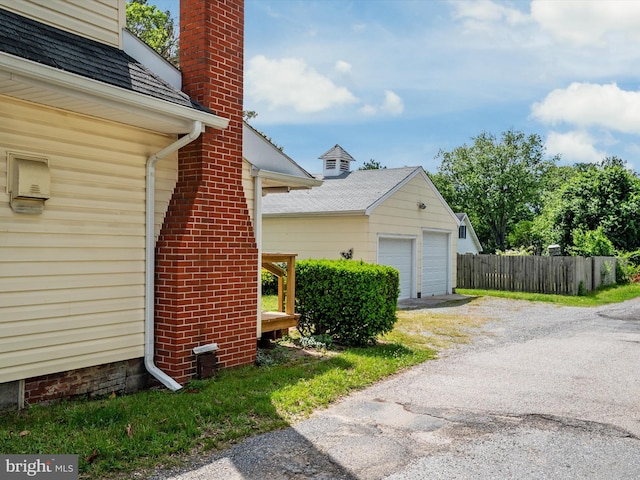 108 S 2nd St, Denton, MD 21629 - view of side of home featuring a chimney and a garage