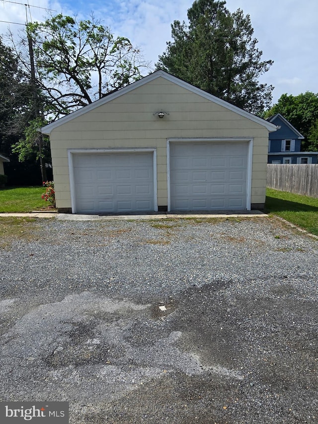detached garage featuring fence