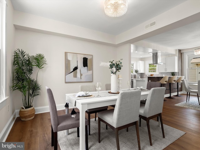 2912 Shirey Ave, Baltimore, MD 21214 - dining room with dark wood-style flooring, a chandelier, and baseboards