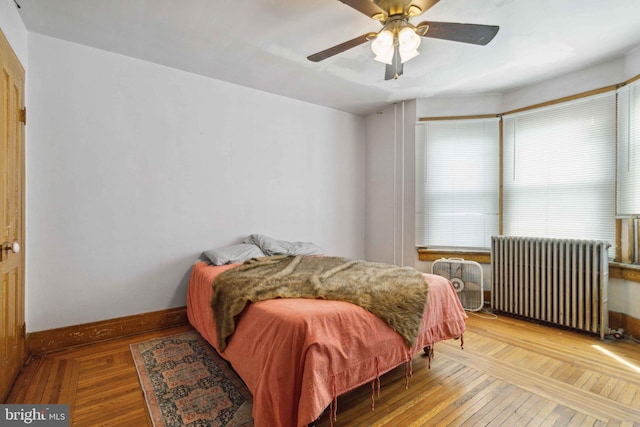 247 W Walnut St, Shamokin, PA 17872 - bedroom with radiator, baseboards, hardwood / wood-style flooring, and ceiling fan