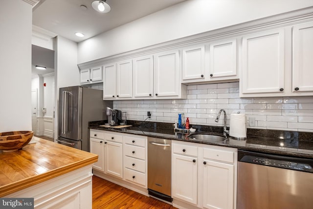 237 N Bread St Unit 2, Philadelphia, PA 19106 - kitchen with appliances with stainless steel finishes, a sink, decorative backsplash, dark stone countertops, and crown molding