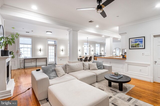 237 N Bread St Unit 2, Philadelphia, PA 19106 - living room with a decorative wall, ornamental molding, a ceiling fan, light wood-style flooring, and plenty of natural light