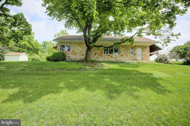 129 Shippensburg Rd, Shippensburg, PA 17257 - view of front of home with stone siding, a front lawn, an outdoor structure, and a shed