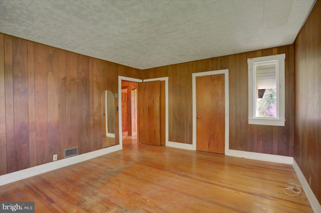 129 Shippensburg Rd, Shippensburg, PA 17257 - spare room with wood finished floors, wood walls, and baseboards