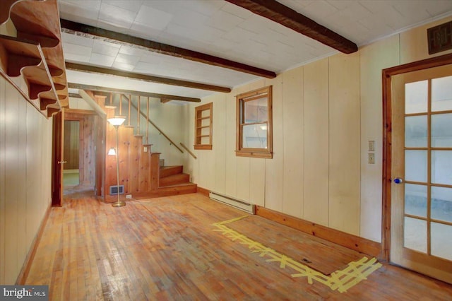 129 Shippensburg Rd, Shippensburg, PA 17257 - basement featuring a baseboard heating unit, hardwood / wood-style flooring, stairs, wooden walls, and baseboards