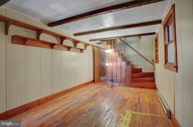 129 Shippensburg Rd, Shippensburg, PA 17257 - below grade area featuring baseboard heating, hardwood / wood-style flooring, wood walls, stairs, and baseboards