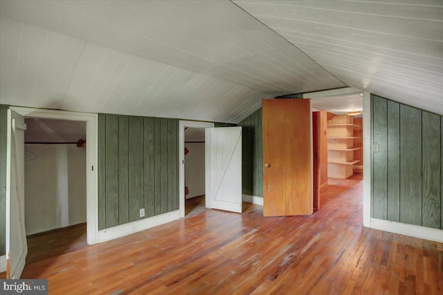 129 Shippensburg Rd, Shippensburg, PA 17257 - additional living space with wood-type flooring, wood walls, lofted ceiling, and baseboards