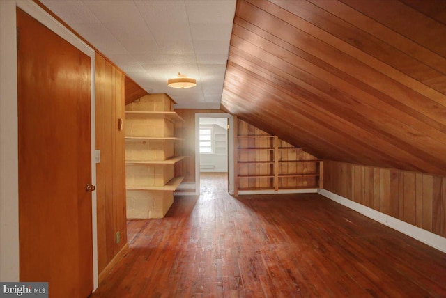 129 Shippensburg Rd, Shippensburg, PA 17257 - additional living space featuring wood-type flooring, wooden walls, lofted ceiling, and baseboards