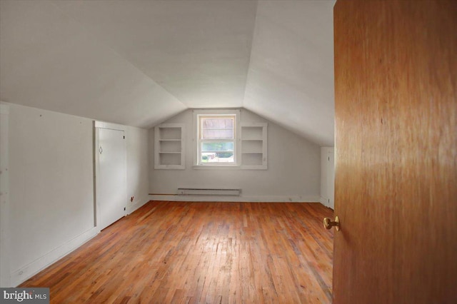 129 Shippensburg Rd, Shippensburg, PA 17257 - bonus room with baseboard heating, vaulted ceiling, hardwood / wood-style flooring, built in shelves, and baseboards