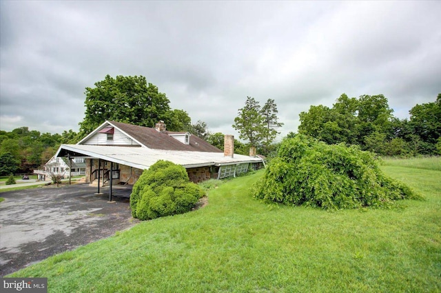 129 Shippensburg Rd, Shippensburg, PA 17257 - view of property exterior with a chimney, driveway, and a lawn