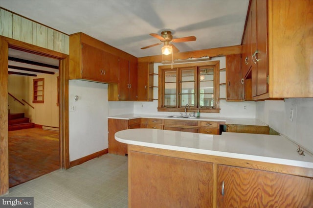 129 Shippensburg Rd, Shippensburg, PA 17257 - kitchen featuring a sink, a peninsula, brown cabinets, and a ceiling fan