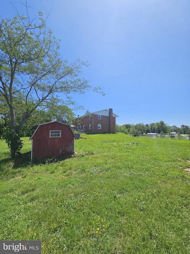 10110 Old Liberty Rd, Frederick, MD 21701 - view of grassy yard featuring a storage unit and an outdoor structure