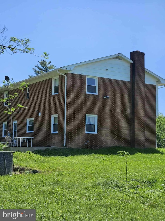 10110 Old Liberty Rd, Frederick, MD 21701 - view of side of property featuring a chimney, a lawn, and brick siding