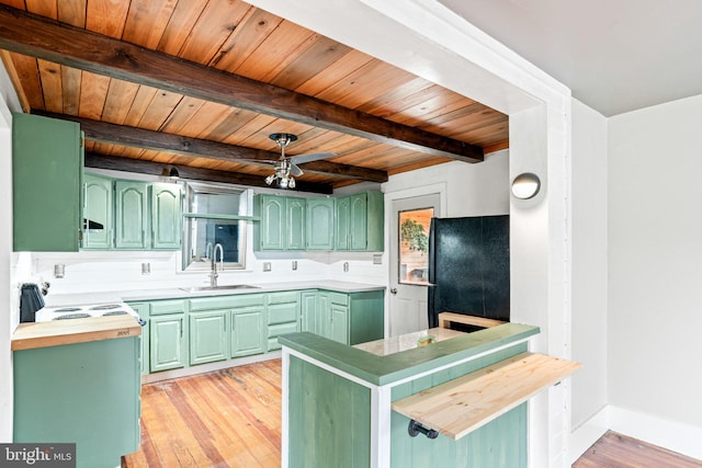 9054 William Penn Hwy, Mifflintown, PA 17059 - kitchen with green cabinets, a sink, freestanding refrigerator, beam ceiling, and light wood-style flooring