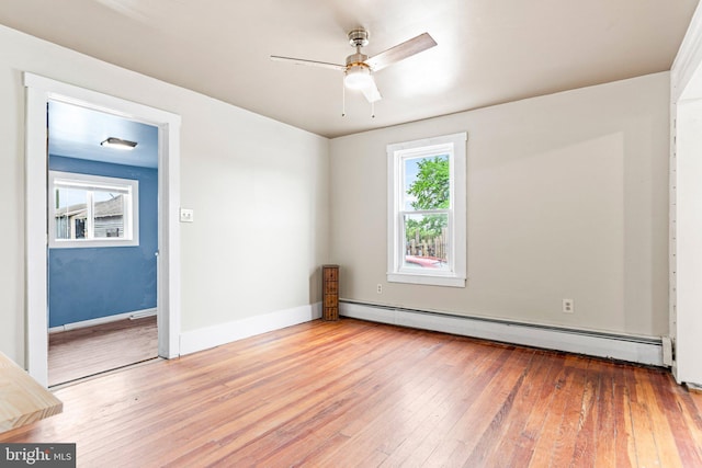 9054 William Penn Hwy, Mifflintown, PA 17059 - unfurnished room featuring a baseboard radiator, hardwood / wood-style floors, a ceiling fan, and baseboards