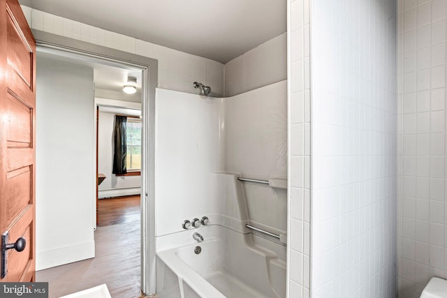 9054 William Penn Hwy, Mifflintown, PA 17059 - full bath with a baseboard heating unit, wood finished floors, and bathing tub / shower combination