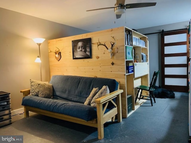 9054 William Penn Hwy, Mifflintown, PA 17059 - living room featuring a barn door, a ceiling fan, and wood walls
