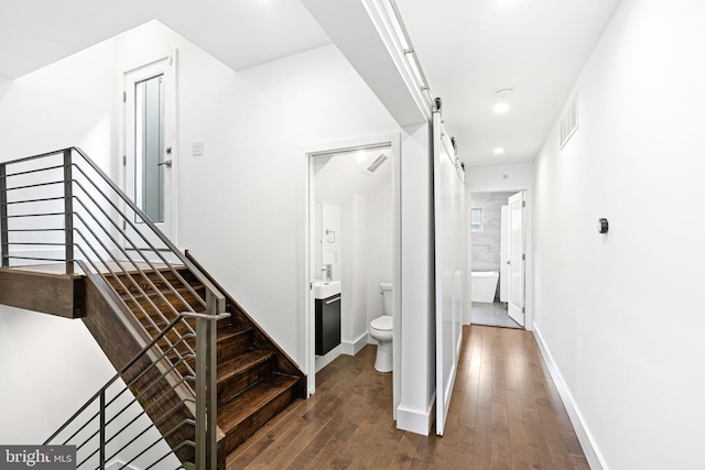 1339 S Garnet St, Philadelphia, PA 19146 - staircase with hardwood / wood-style flooring, a barn door, recessed lighting, and baseboards