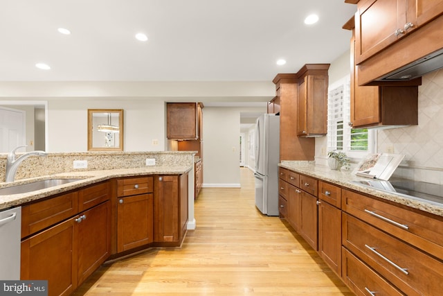 1802 24th St S, Arlington, VA 22202 - kitchen featuring freestanding refrigerator, light wood-type flooring, tasteful backsplash, brown cabinets, and recessed lighting