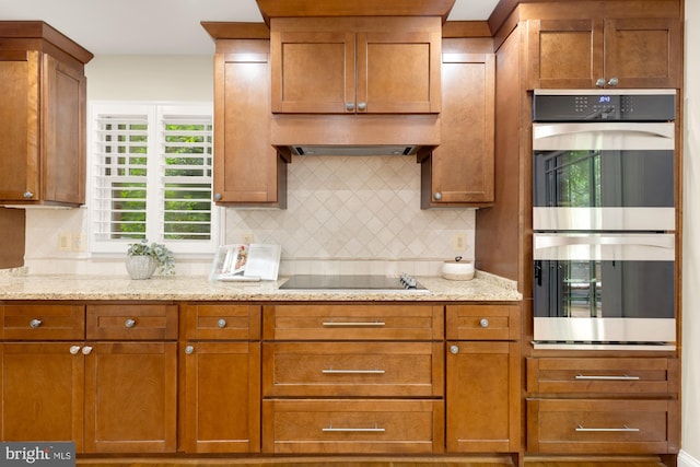 1802 24th St S, Arlington, VA 22202 - kitchen with stainless steel double oven, black electric stovetop, tasteful backsplash, and brown cabinets