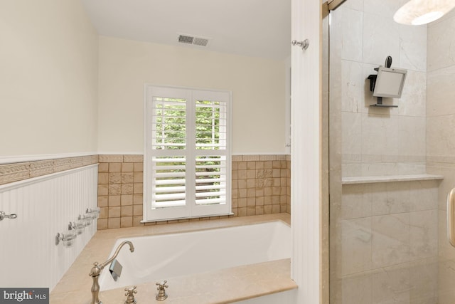 1802 24th St S, Arlington, VA 22202 - bathroom with a bath, a stall shower, and a wainscoted wall