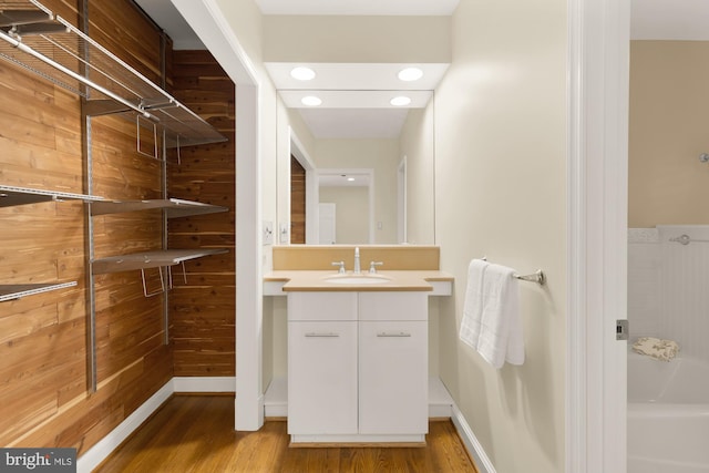 1802 24th St S, Arlington, VA 22202 - bathroom with wood finished floors, vanity, a tub to relax in, and recessed lighting