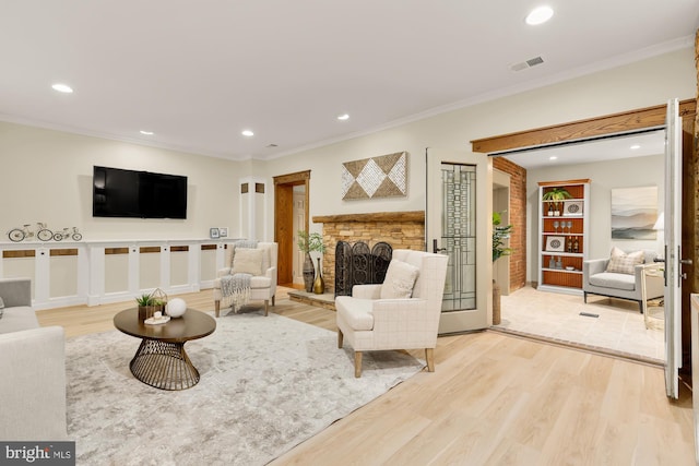 1802 24th St S, Arlington, VA 22202 - living room featuring recessed lighting, crown molding, a stone fireplace, and light wood-type flooring
