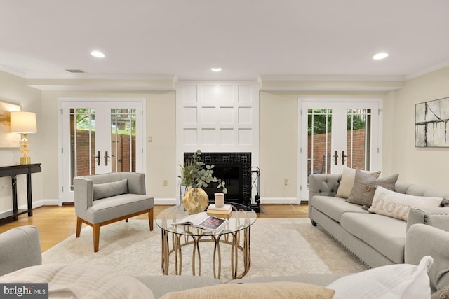 1802 24th St S, Arlington, VA 22202 - living area with french doors, crown molding, light wood-style flooring, recessed lighting, and a fireplace with flush hearth