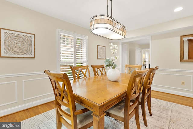 1802 24th St S, Arlington, VA 22202 - dining area featuring light wood-style flooring, a decorative wall, and wainscoting