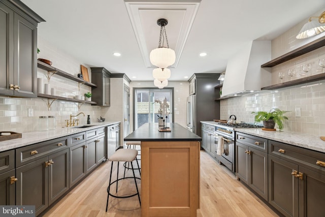 826 Tasker St, Philadelphia, PA 19148 - kitchen with open shelves, a sink, light wood-style flooring, premium appliances, and backsplash