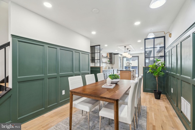 826 Tasker St, Philadelphia, PA 19148 - dining space featuring light wood-style floors, a chandelier, a decorative wall, and recessed lighting