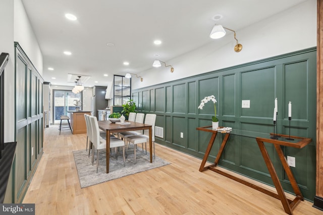 826 Tasker St, Philadelphia, PA 19148 - dining room with a decorative wall, light wood-style floors, a wainscoted wall, and recessed lighting