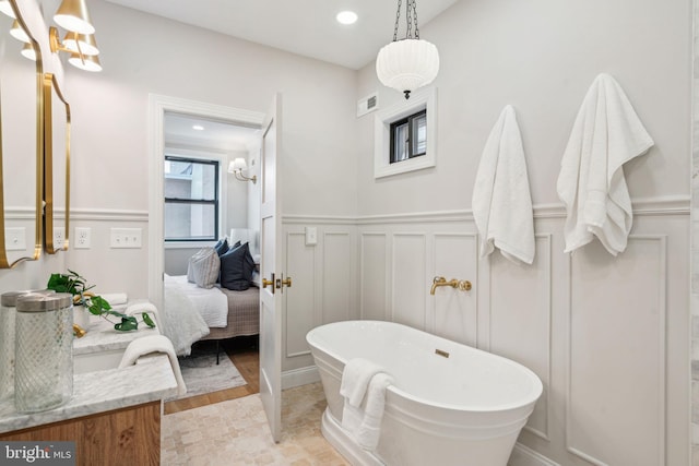 826 Tasker St, Philadelphia, PA 19148 - bathroom with a decorative wall, a freestanding bath, ensuite bathroom, vanity, and a wainscoted wall