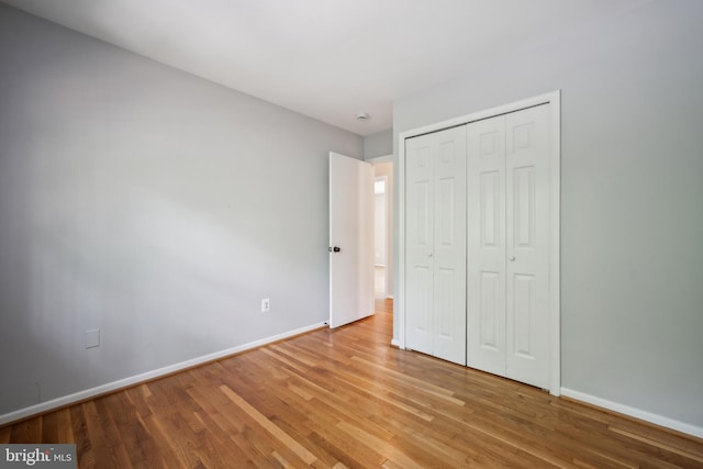 8818 Olympia Fields Ln, Vienna, VA 22182 - unfurnished bedroom with baseboards, light wood-type flooring, and a closet