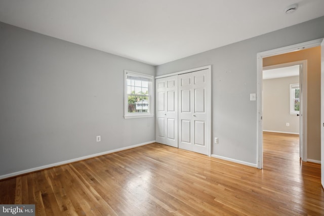8818 Olympia Fields Ln, Vienna, VA 22182 - unfurnished bedroom featuring light wood-style floors, baseboards, and a closet