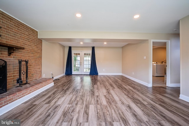 8818 Olympia Fields Ln, Vienna, VA 22182 - unfurnished living room featuring baseboards, wood finished floors, a fireplace, and washing machine and clothes dryer