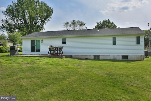 rear view of house with a lawn